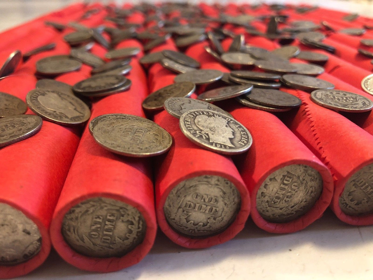 TIGHTLY CRIMPED RED BANK WRAPPED ROLLS OF WHEAT CENTS WITH BARBER DIMES SHOWING