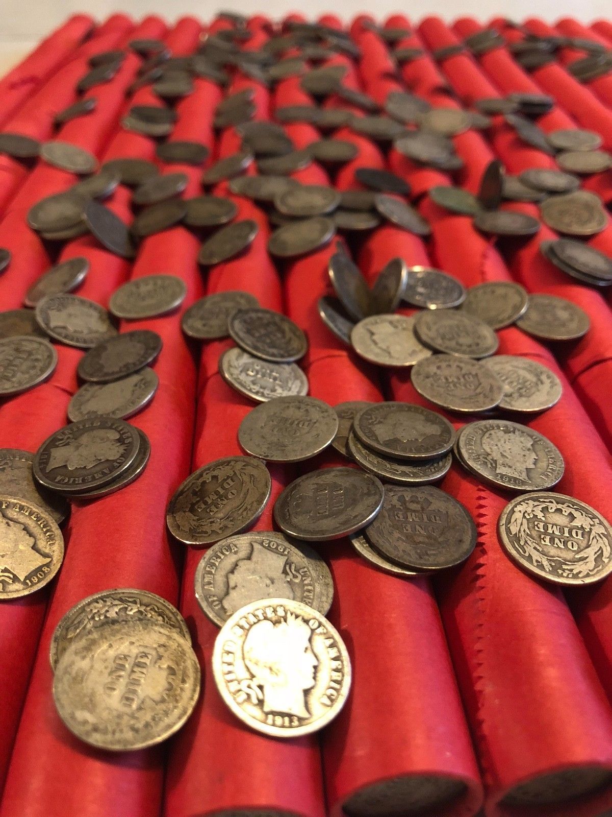 TIGHTLY CRIMPED RED BANK WRAPPED ROLLS OF WHEAT CENTS WITH BARBER DIMES SHOWING