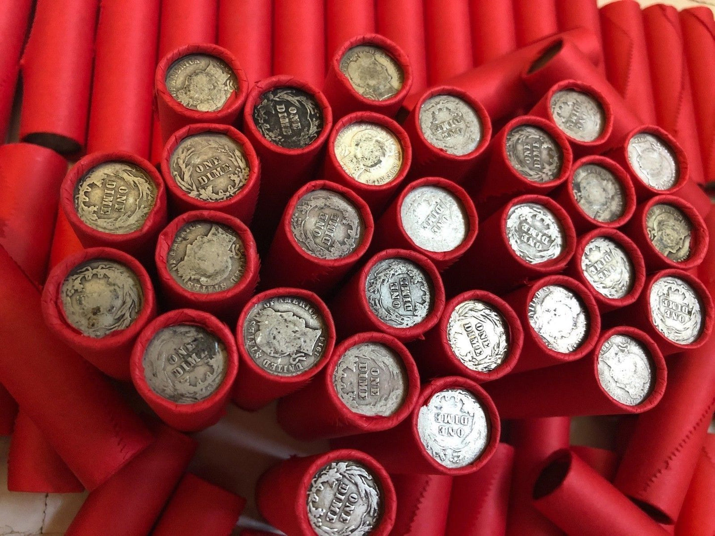 TIGHTLY CRIMPED RED BANK WRAPPED ROLLS OF WHEAT CENTS WITH BARBER DIMES SHOWING