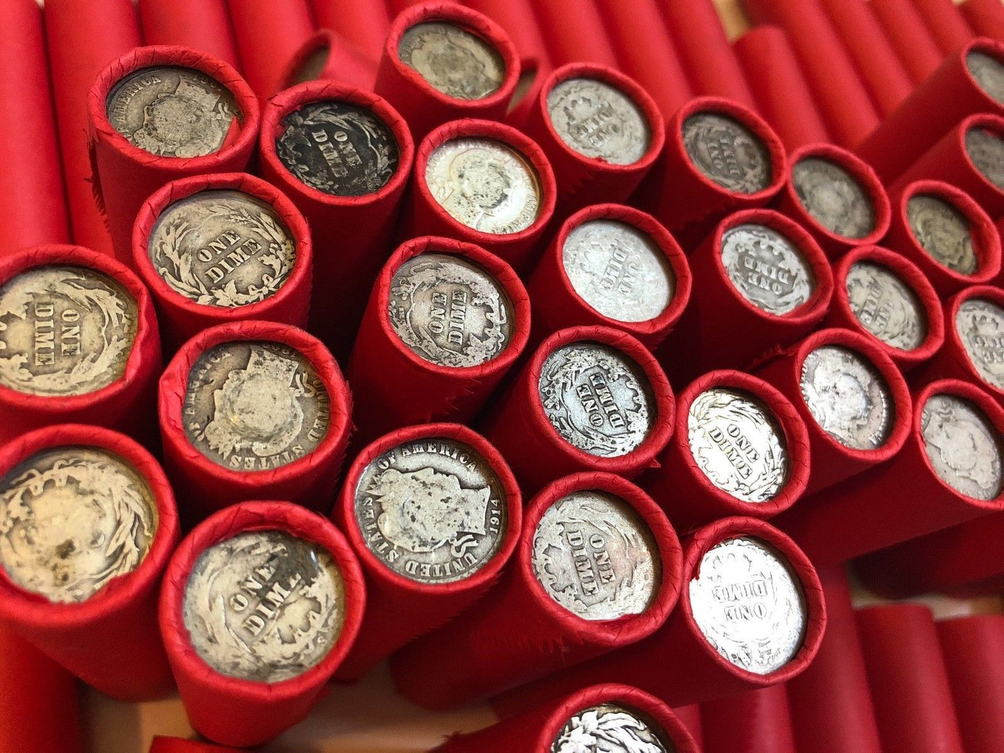 TIGHTLY CRIMPED RED BANK WRAPPED ROLLS OF WHEAT CENTS WITH BARBER DIMES SHOWING