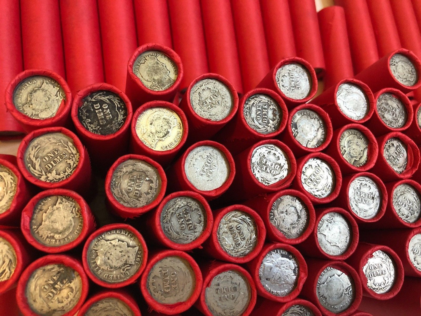 TIGHTLY CRIMPED RED BANK WRAPPED ROLLS OF WHEAT CENTS WITH BARBER DIMES SHOWING