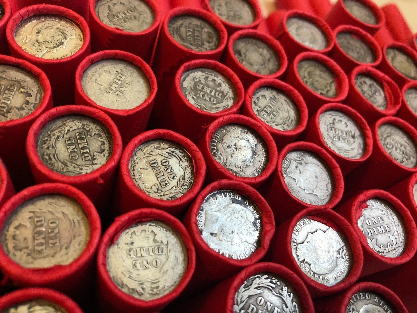 TIGHTLY CRIMPED RED BANK WRAPPED ROLLS OF WHEAT CENTS WITH BARBER DIMES SHOWING